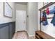 Inviting entryway features a coat rack, bench, wood-look flooring and a convenient organizational calendar at 4840 Point Mesa St, Castle Rock, CO 80108