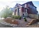 Charming two-story home features stone accents, landscaped front yard, and inviting curb appeal at 4840 Point Mesa St, Castle Rock, CO 80108