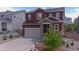 Charming two-story home with stone accents, a well-maintained lawn, and a spacious two car garage at 4840 Point Mesa St, Castle Rock, CO 80108