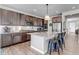 Well-equipped kitchen featuring stainless steel appliances, ample cabinet space, granite countertops, and a large island with seating at 4840 Point Mesa St, Castle Rock, CO 80108