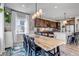 Open kitchen and dining area featuring granite countertops, stainless steel appliances and a large island with a breakfast bar at 4840 Point Mesa St, Castle Rock, CO 80108