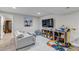 Inviting play room offering a large couch, mounted TV, and numerous toys, perfect for a growing Gathering at 4840 Point Mesa St, Castle Rock, CO 80108