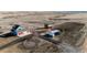 Wide aerial shot of property with house, garage, and barns, surrounded by open fields and training tracks at 52900 E 88Th Ave, Strasburg, CO 80136
