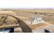 Areal view of light blue house, garage and surrounding fields, situated on a large lot with mature trees at 52900 E 88Th Ave, Strasburg, CO 80136
