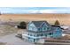 Aerial view of the property, featuring a barn, a home, and scenic views at 52900 E 88Th Ave, Strasburg, CO 80136