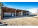 View of the property's open air metal barn with metal dividers and equipment at 52900 E 88Th Ave, Strasburg, CO 80136