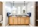 Bathroom with double sink vanity and well-lit mirrors at 52900 E 88Th Ave, Strasburg, CO 80136