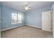 Comfortable bedroom with plush carpeting, large window, and a ceiling fan at 52900 E 88Th Ave, Strasburg, CO 80136