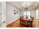 Bright dining room with a wood table, matching chairs, hardwood floors, and lots of natural light at 52900 E 88Th Ave, Strasburg, CO 80136