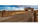 Gated entrance leads to a charming home with a long driveway at 52900 E 88Th Ave, Strasburg, CO 80136