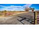 Gated entrance leads to a charming home with a long driveway at 52900 E 88Th Ave, Strasburg, CO 80136