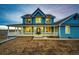Charming two-story home with a covered porch and well-manicured landscaping at 52900 E 88Th Ave, Strasburg, CO 80136