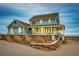 Rear view of beautiful two-story home with walk-out basement and retaining wall at 52900 E 88Th Ave, Strasburg, CO 80136