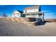 Beautiful two-story home featuring a charming porch and professional landscaping, set against a bright blue sky at 52900 E 88Th Ave, Strasburg, CO 80136