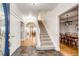 Bright foyer with tile flooring, staircase, and views into the dining room at 52900 E 88Th Ave, Strasburg, CO 80136