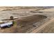Wide view of the property's horse arena, with its wooden perimeter and surrounding field at 52900 E 88Th Ave, Strasburg, CO 80136