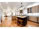 Modern kitchen featuring stainless steel appliances, wood cabinets, island with seating, and open to living space at 52900 E 88Th Ave, Strasburg, CO 80136