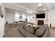 Inviting living area with stylish gray sofa, fireplace, and a game table, illuminated by recessed lighting at 52900 E 88Th Ave, Strasburg, CO 80136