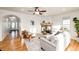 Sunlit living room featuring a fireplace, hardwood floors, and an inviting leather chair at 52900 E 88Th Ave, Strasburg, CO 80136