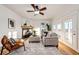Bright living room with fireplace, plush seating, stylish decor, and view to the outside at 52900 E 88Th Ave, Strasburg, CO 80136