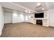 Large and spacious living room featuring a fireplace with built-in shelving and neutral carpet at 52900 E 88Th Ave, Strasburg, CO 80136