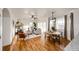 Open-concept living space with fireplace, dining area, and hardwood floors throughout at 52900 E 88Th Ave, Strasburg, CO 80136