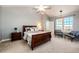 Main bedroom featuring a vaulted ceiling, large window, and an upholstered bed at 52900 E 88Th Ave, Strasburg, CO 80136