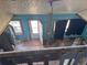 Attic room featuring blue walls, wood floors, and an exterior door leading outside at 660 Hickory St, Hudson, CO 80642