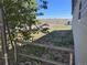 Overgrown yard with a chain-link fence. Ready to be transformed into your own private outdoor space at 660 Hickory St, Hudson, CO 80642