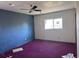 Bedroom with purple carpet, a new window, and textured walls ready for renovation at 660 Hickory St, Hudson, CO 80642