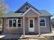 Charming home with a quaint front porch and newly installed windows adding to its curb appeal at 660 Hickory St, Hudson, CO 80642