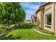 Lush backyard with manicured lawn, mature trees, and well-maintained landscaping; mountain views at 11784 Spruce Mountain Rd, Larkspur, CO 80118