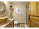 Cozy bathroom with custom vanity, granite counters, unique bowl sink, and glass shower door at 11784 Spruce Mountain Rd, Larkspur, CO 80118