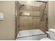 Bathroom featuring tiled shower and bathtub combination with glass doors and tile surround at 11784 Spruce Mountain Rd, Larkspur, CO 80118