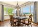 Spacious dining room with wooden table and chairs and a view at 11784 Spruce Mountain Rd, Larkspur, CO 80118