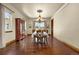 Elegant dining room featuring hardwood floors, large windows, and a stylish chandelier at 11784 Spruce Mountain Rd, Larkspur, CO 80118