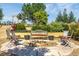Cozy backyard firepit area surrounded by comfortable seating and lush greenery at 11784 Spruce Mountain Rd, Larkspur, CO 80118