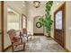Welcoming foyer with tile floors, a decorative light fixture, and a stylish plant at 11784 Spruce Mountain Rd, Larkspur, CO 80118