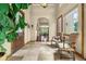 Spacious foyer with tile floors, a large plant, and views into the dining area at 11784 Spruce Mountain Rd, Larkspur, CO 80118
