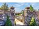 Charming stone gate with decorative accents leading to a serene outdoor space and landscaping at 11784 Spruce Mountain Rd, Larkspur, CO 80118