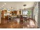 Open-concept kitchen and dining area with hardwood floors, granite countertops, and stainless steel appliances at 11784 Spruce Mountain Rd, Larkspur, CO 80118
