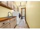 Convenient laundry room with modern washer and dryer, ample storage, and butcher block countertop at 11784 Spruce Mountain Rd, Larkspur, CO 80118