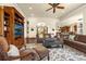Comfortable living room with built-in shelving and open floorplan to the kitchen and dining area at 11784 Spruce Mountain Rd, Larkspur, CO 80118