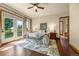 Bright primary bedroom with outdoor access, and views, featuring hardwood floors and a sitting area at 11784 Spruce Mountain Rd, Larkspur, CO 80118