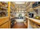 Walk-in pantry with custom shelving, wooden floor, and ample storage for all your needs at 11784 Spruce Mountain Rd, Larkspur, CO 80118