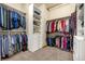 Spacious walk-in closet with custom shelves, rods, drawers, and plenty of room for clothes and storage at 11784 Spruce Mountain Rd, Larkspur, CO 80118