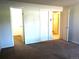 A spacious bedroom with multiple doorways offers easy access to other areas of the home at 17331 E Mansfield Ave # 311L, Aurora, CO 80013
