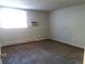 This bedroom features carpeted floors and an air conditioner, offering a comfortable and cool living space at 17331 E Mansfield Ave # 311L, Aurora, CO 80013