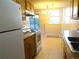 Kitchen with neutral countertops, tiled flooring, white appliances and eat in dining area at 17331 E Mansfield Ave # 311L, Aurora, CO 80013