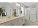 Bright bathroom featuring a double vanity with modern fixtures and a glass-enclosed shower at 3193 Belleville Ridge Rd, Elizabeth, CO 80107
